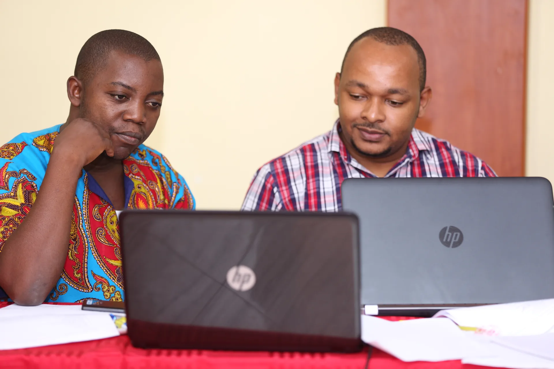 Two learners studying on a laptop