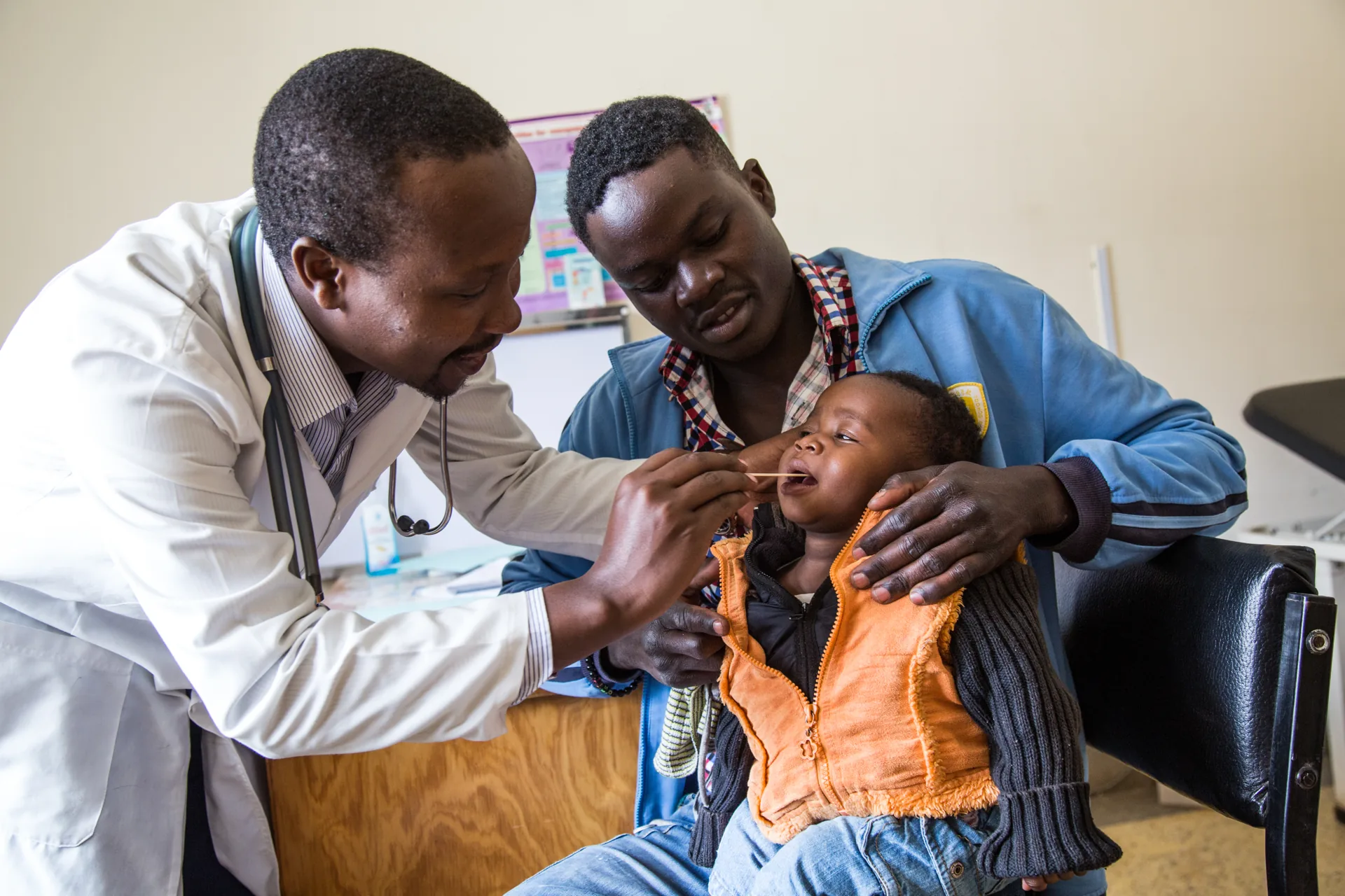 A clinician examining a child with the mother